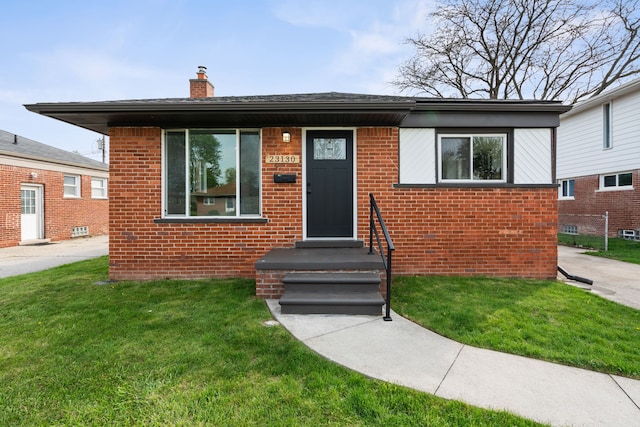 23130 Beverly St, Saint Clair Shores, MI 48082 - view of front facade featuring a front lawn, a chimney, and brick siding