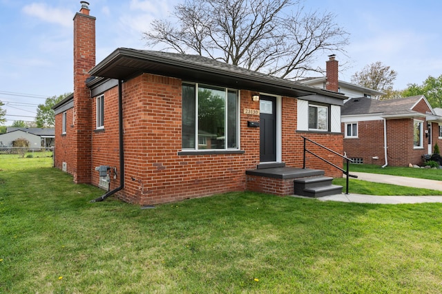23130 Beverly St, Saint Clair Shores, MI 48082 - view of front facade with a chimney and brick siding