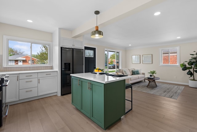 23130 Beverly St, Saint Clair Shores, MI 48082 - kitchen with green cabinets, stainless steel fridge, light wood-style flooring, light countertops, and open floor plan