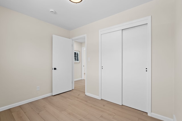 23130 Beverly St, Saint Clair Shores, MI 48082 - unfurnished bedroom featuring light wood-type flooring, baseboards, and a closet