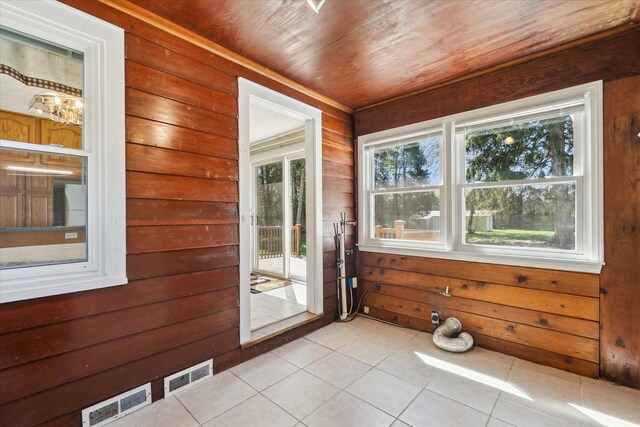 unfurnished sunroom with visible vents