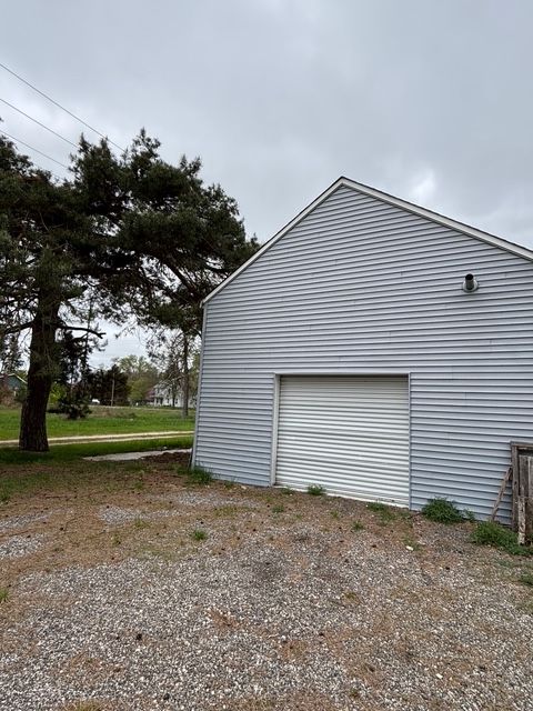 view of property exterior featuring an outdoor structure and a garage