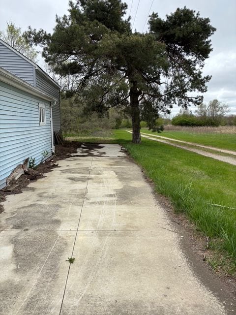 view of road with concrete driveway