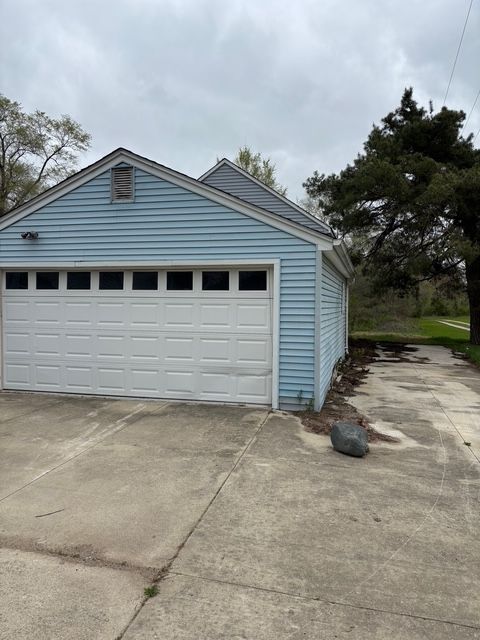 garage with concrete driveway