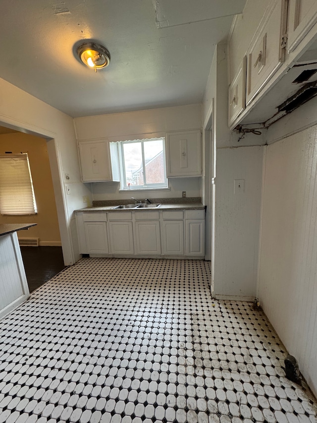kitchen with visible vents, a sink, and white cabinetry