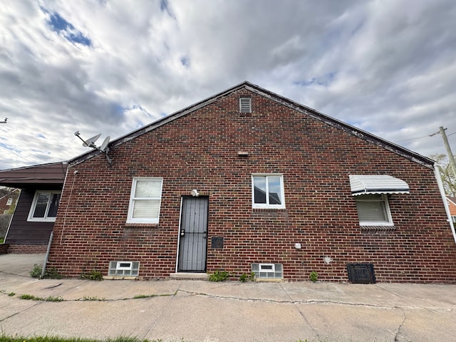 back of house with brick siding