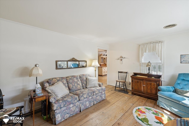 7309 N Genesee Rd, Genesee, MI 48437 - living area featuring visible vents, ornamental molding, and hardwood / wood-style flooring