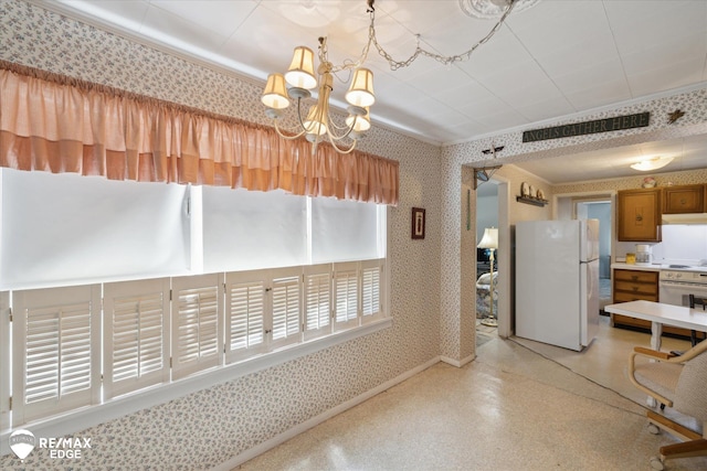 7309 N Genesee Rd, Genesee, MI 48437 - kitchen with freestanding refrigerator, wallpapered walls, visible vents, and brown cabinetry