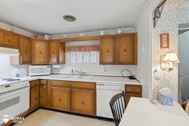 7309 N Genesee Rd, Genesee, MI 48437 - kitchen featuring a sink, brown cabinets, under cabinet range hood, and white appliances