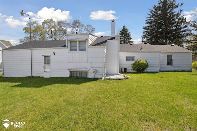 7309 N Genesee Rd, Genesee, MI 48437 - rear view of house with a lawn, roof with shingles, and a chimney