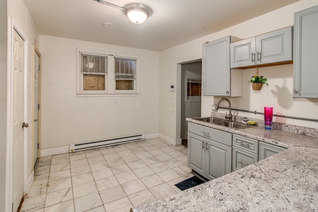 1636 N Grand Traverse St, Flint, MI 48503 - kitchen featuring baseboards, a sink, a baseboard heating unit, and gray cabinetry