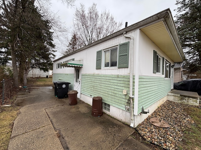 view of property exterior with a patio