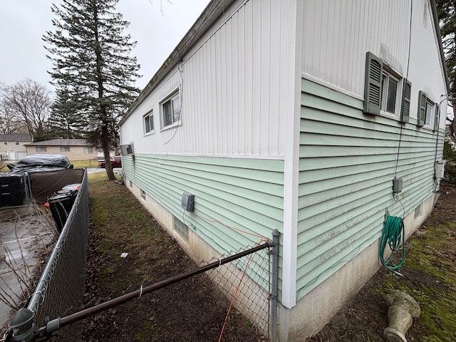 view of home's exterior featuring fence