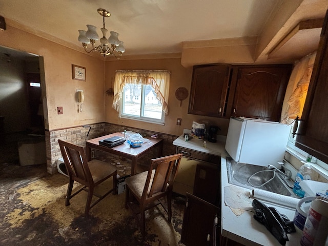 dining space featuring a notable chandelier and a wainscoted wall