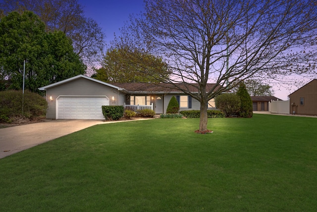 single story home featuring a yard, driveway, covered porch, and a garage