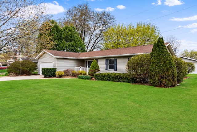 single story home with concrete driveway, a front yard, roof with shingles, and an attached garage