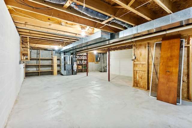 unfinished below grade area with gas water heater and heating unit
