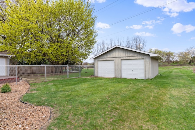 view of yard with an outbuilding, fence, and a detached garage