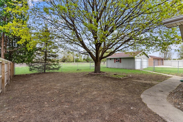 view of yard with an outdoor structure and a fenced backyard