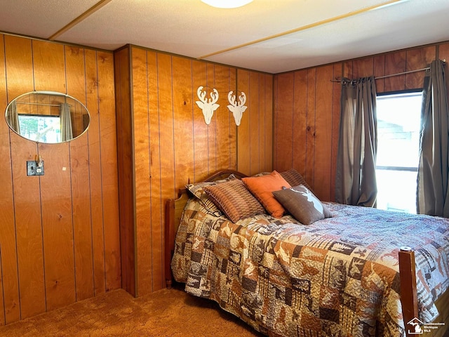 bedroom with carpet flooring, wooden walls, and multiple windows