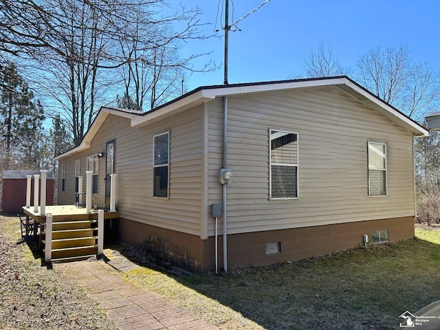 view of property exterior featuring a wooden deck and crawl space