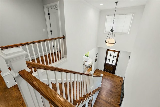 foyer entrance featuring stairway, baseboards, and wood finished floors