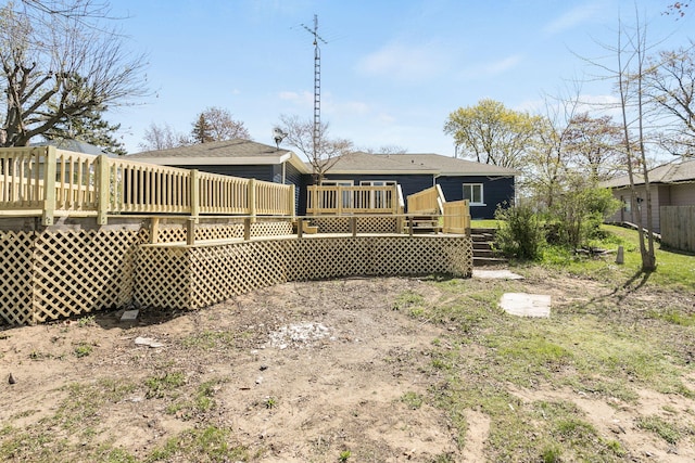 back of house with a wooden deck