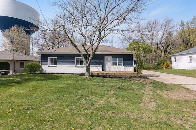 view of front of home with concrete driveway and a front yard