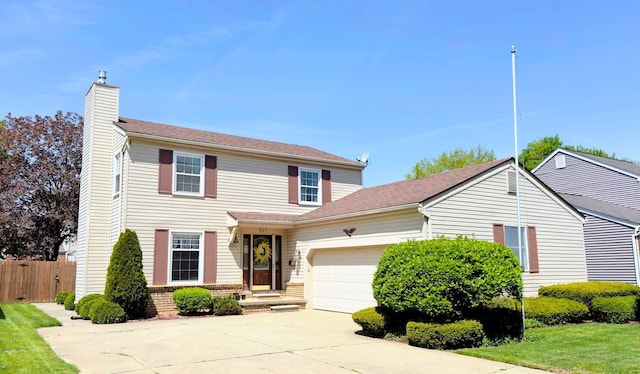 traditional-style home featuring an attached garage, fence, driveway, and a chimney