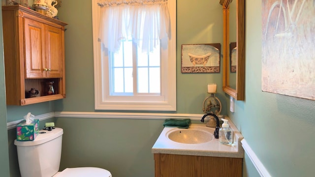 bathroom featuring vanity and toilet