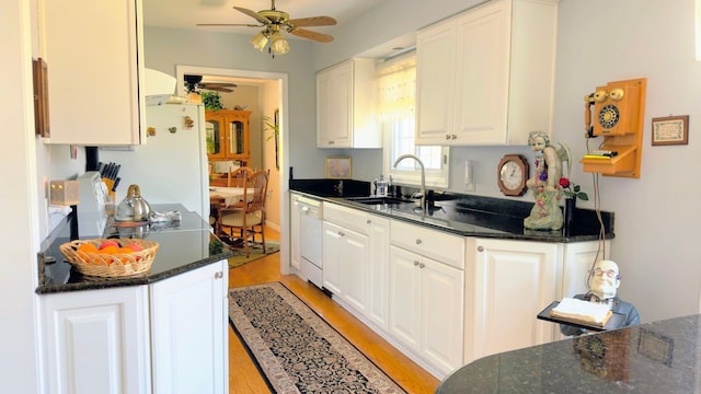 kitchen featuring ceiling fan, a sink, white cabinets, white appliances, and light wood-style flooring