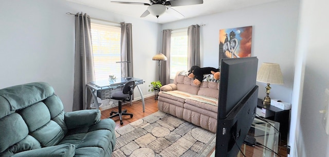 office area featuring baseboards, a ceiling fan, and wood finished floors