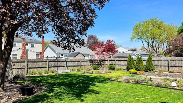 view of yard with a residential view and a fenced backyard