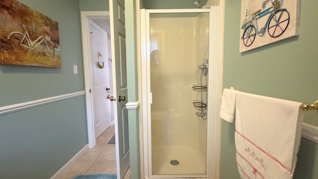 bathroom featuring tile patterned flooring and a shower stall