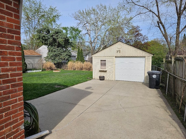 detached garage with fence and driveway