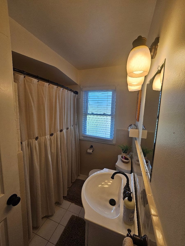 full bathroom featuring a shower with shower curtain, tile patterned flooring, and vanity