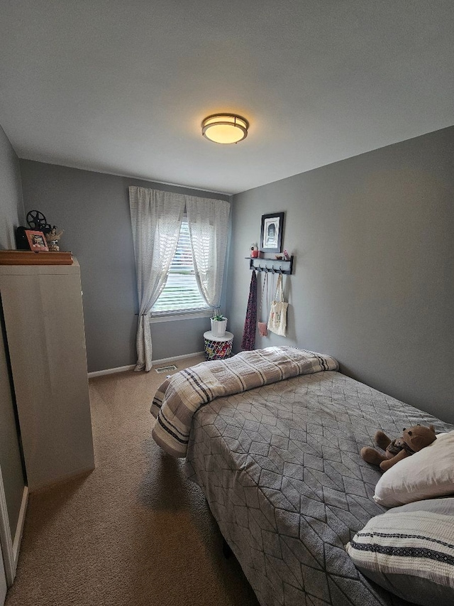 carpeted bedroom featuring baseboards