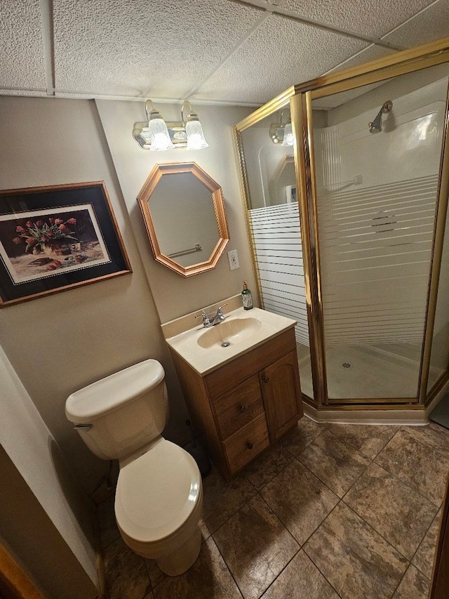 bathroom with vanity, tile patterned floors, a stall shower, and toilet