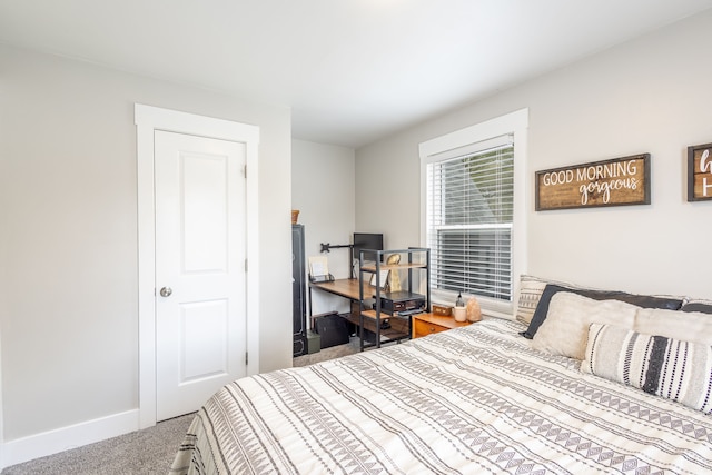 carpeted bedroom featuring baseboards
