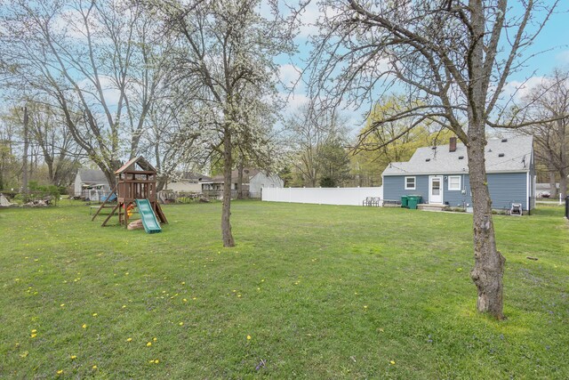 view of yard featuring a playground and fence