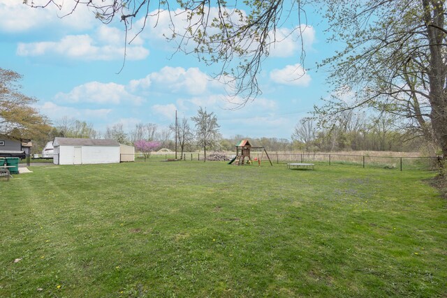 view of yard with a playground and a fenced backyard
