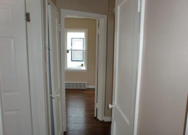 19724 Elkhart St, Harper Woods, MI 48225 - corridor featuring dark wood-style flooring, baseboards, and visible vents