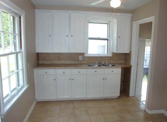 19724 Elkhart St, Harper Woods, MI 48225 - kitchen featuring a sink, light countertops, and white cabinets