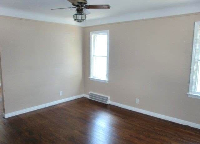 19724 Elkhart St, Harper Woods, MI 48225 - empty room with visible vents, baseboards, ceiling fan, and wood finished floors