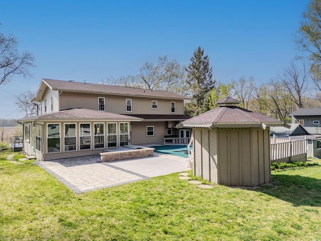 back of house with a patio, a fenced in pool, a sunroom, a gazebo, and a yard
