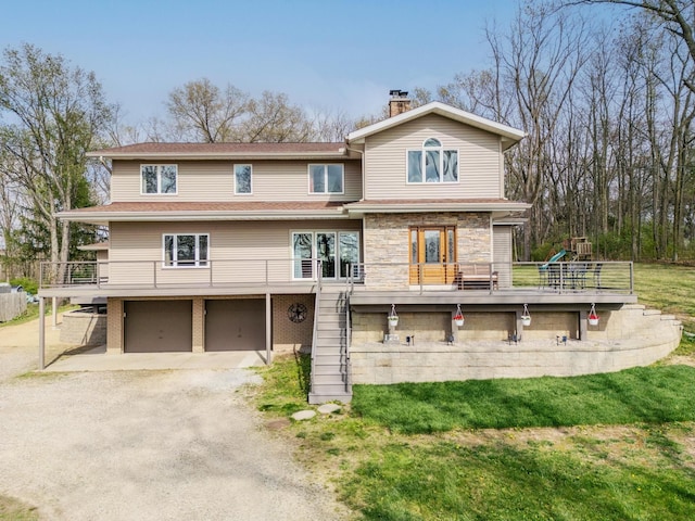 townhome / multi-family property featuring a chimney, dirt driveway, a deck, a garage, and stone siding