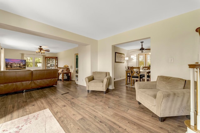 living room featuring ceiling fan and wood finished floors