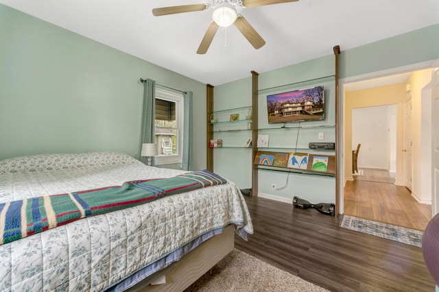 bedroom with baseboards, a ceiling fan, and wood finished floors