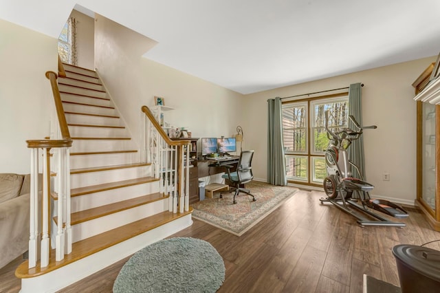 interior space featuring baseboards and wood finished floors