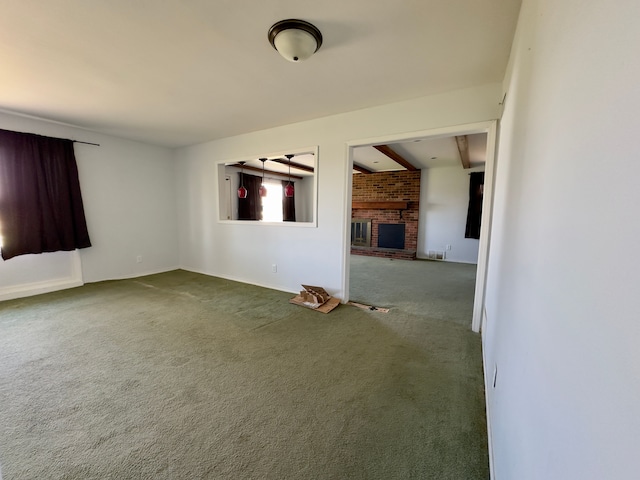 spare room with carpet floors, baseboards, and a brick fireplace